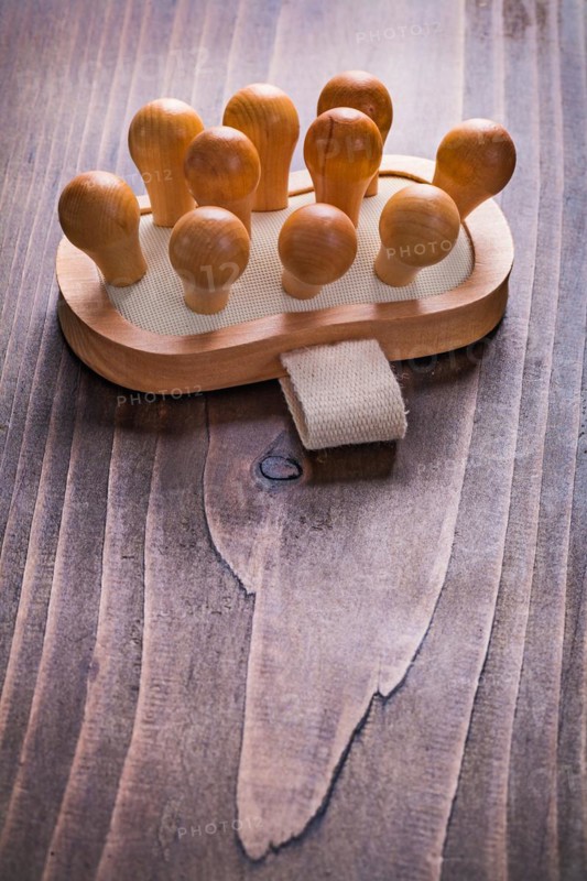 Classic wooden massager on vintage board