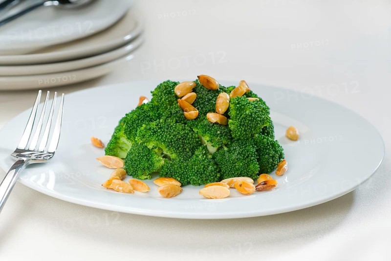 Fresh and vivid sauteed broccoli and almonds very ealthy food