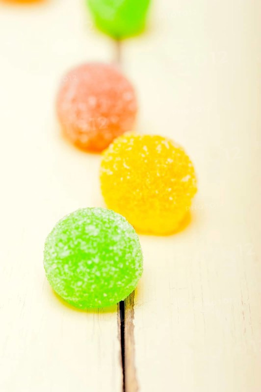 Sugar jelly fruit candy over white wood table