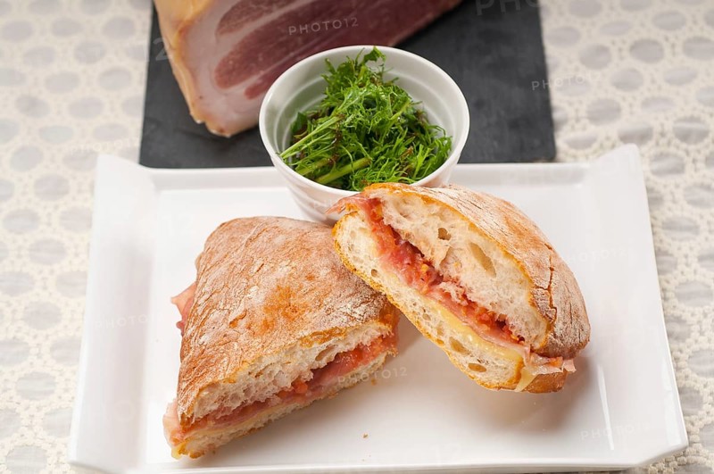 Italian ciabatta panini sandwich with parma ham and tomato