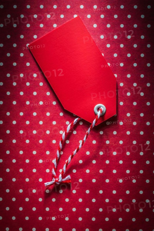 Red sale tag on polka-dot background