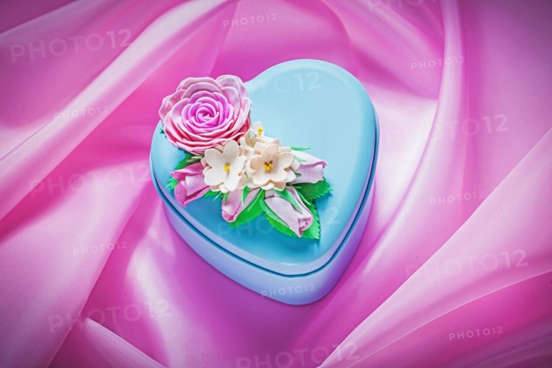 Blue metal gift box on pink fabric background holidays concept