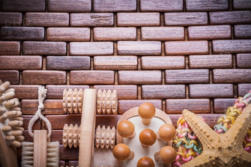 Group of bathing articles on textured wooden table mat healthcare concept