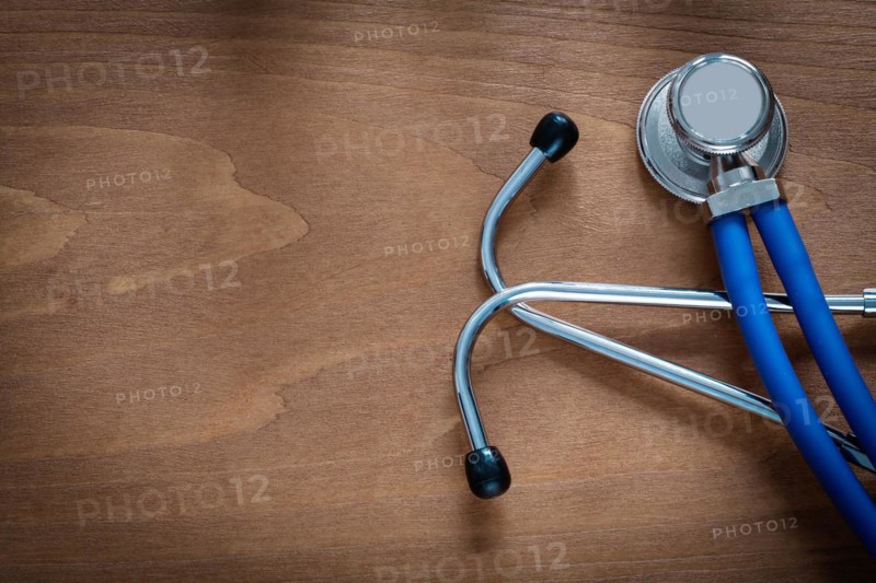 Horizontal view of stethoscope for medical examination on pine vintage wooden board medicine concept