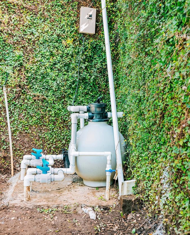 Pool purification and maintenance system. Home pool filter and treatment plant installed. Pool pump with sand filter installed