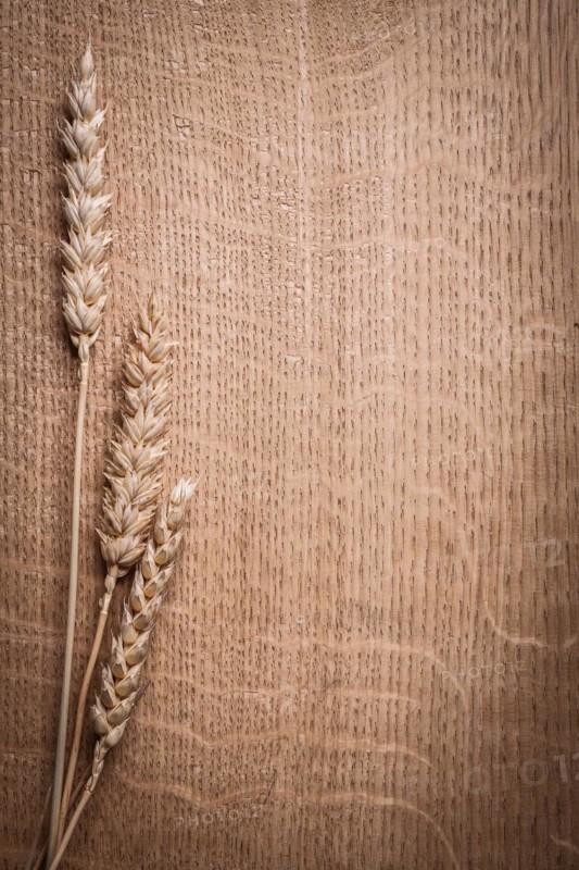 Copyspace image Ears of ripe wheat on wooden board close-up