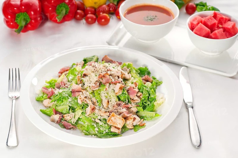 Fresh classic caesar salad served with gazpacho soup