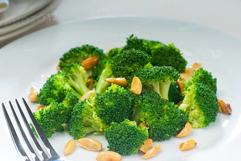 Fresh and vivid sauteed broccoli and almonds very ealthy food