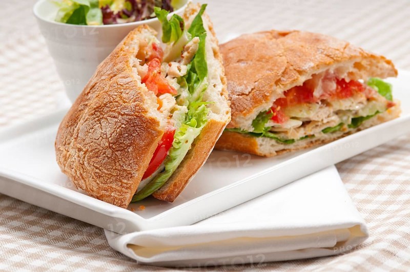 Italian ciabatta panini sandwich with chicken and tomato