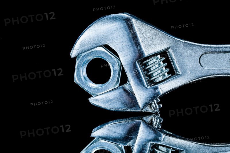Construction nut adjustable wrench on black background