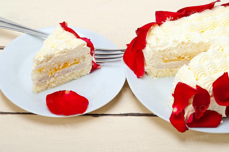 Whipped cream mango cake with red rose petals