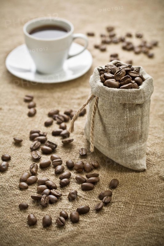 Coffee beans and a cup of coffee on a bag