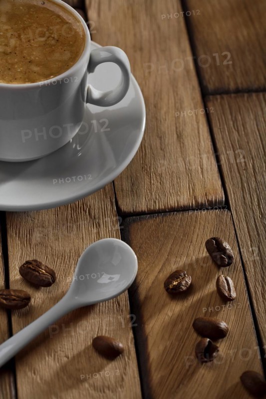 Coffee cup and spoon on wooden table