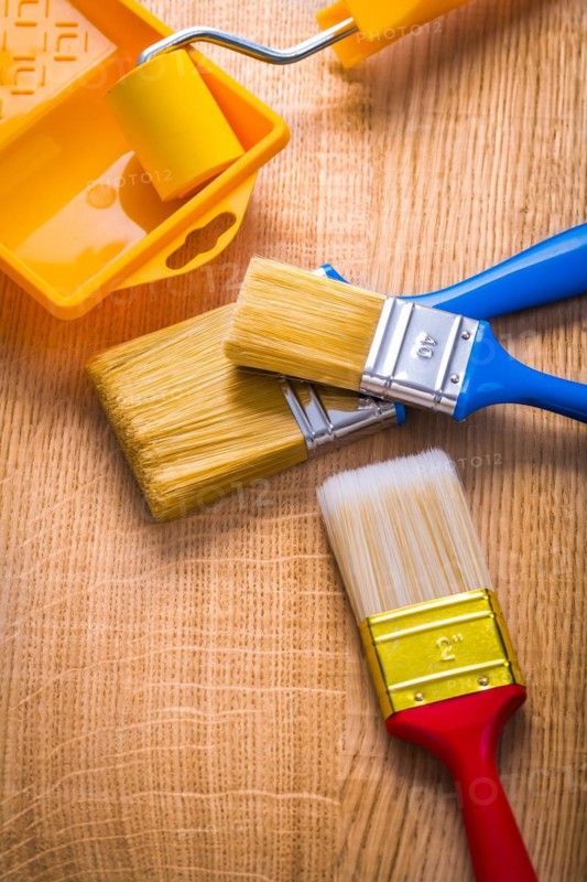 Compsition three brush roller and tray on wooden board