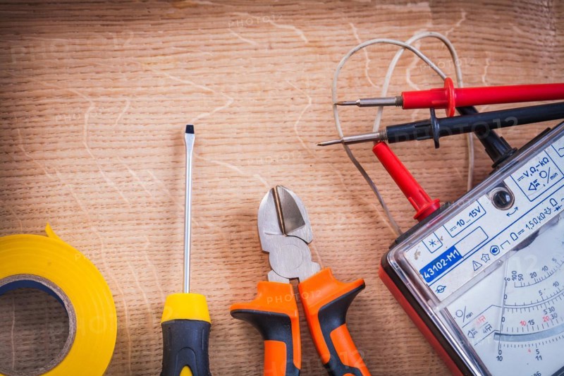 Electrical tools Multimeter Tester Pliers Screwdriver Roller Insulating tape On wooden board