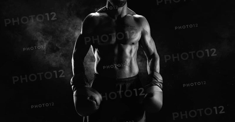 Noname image of a kickboxer on a dark background. The concept of mixed martial arts. MMA