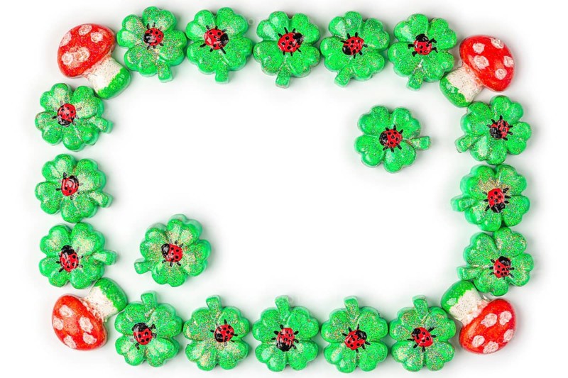 A frame of shamrocks with ladybirds and toadstools