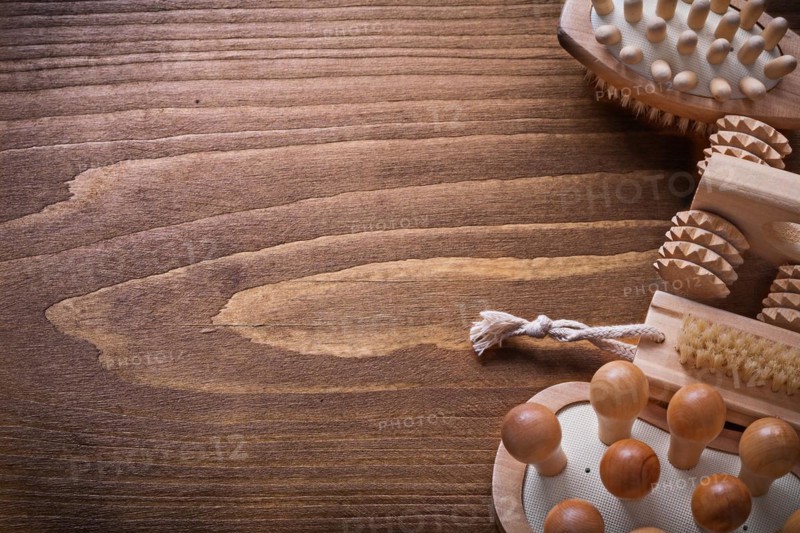 Helthcare background wooden sauna massager and nail brush on vintage board with copyspace