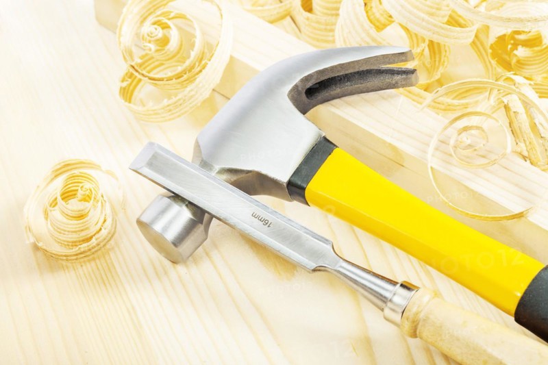 Chisel with hammer on wood