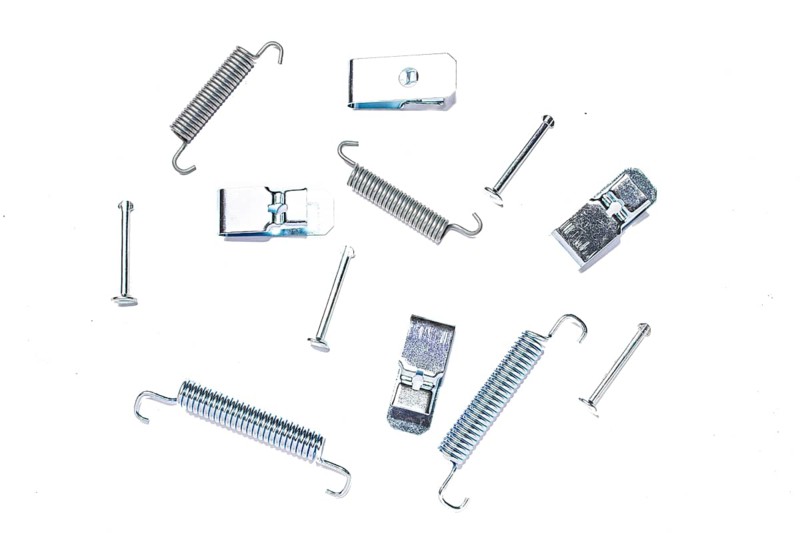 Repair kit of springs and clips for parking brake pads on white isolated background