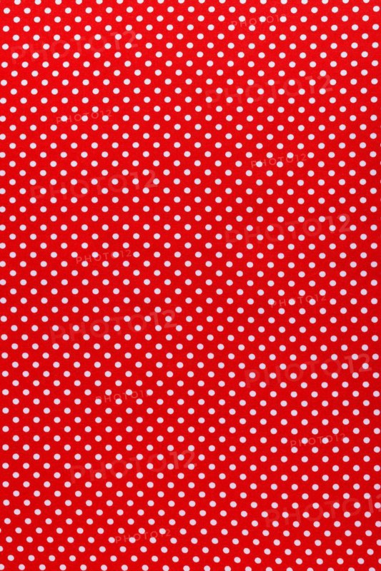 Red polka-dot cotton fabric vertical view
