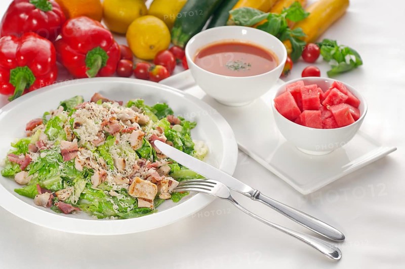 Fresh classic caesar salad served with gazpacho soup