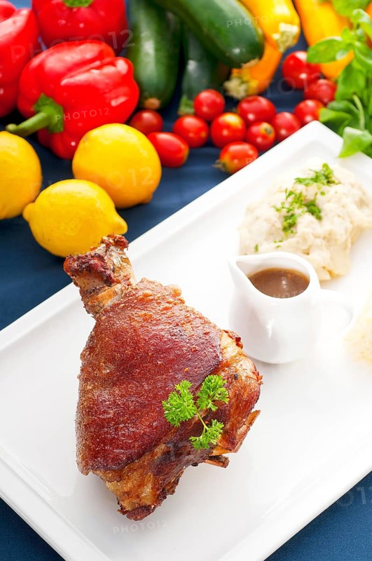 Original German BBQ pork knuckle served with mashed potatoes and sauerkraut