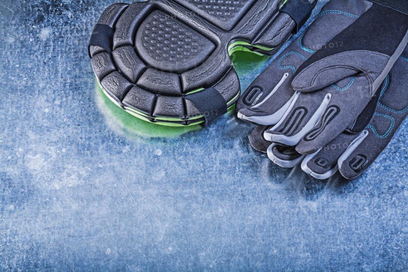 Gardening safety gloves knee protectors on metallic background agriculture concept