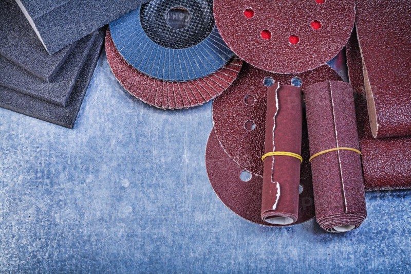 Assortment of abrasive materials on metallic background