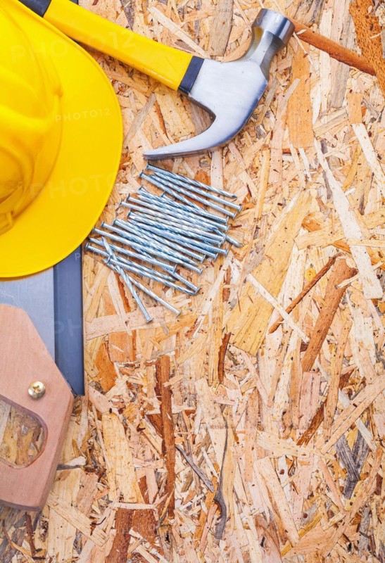 Construction tools Helmet Handsaw Claw hammer Nails on plywood