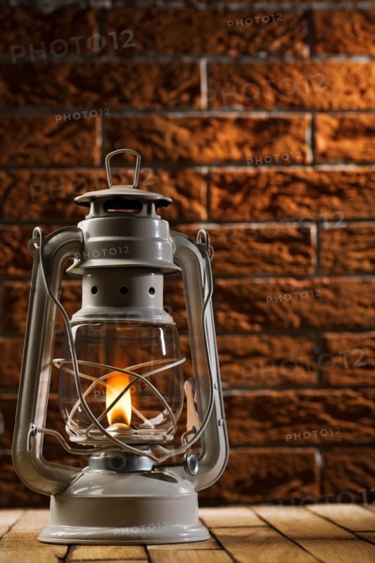 Kerosene lamp on brick background