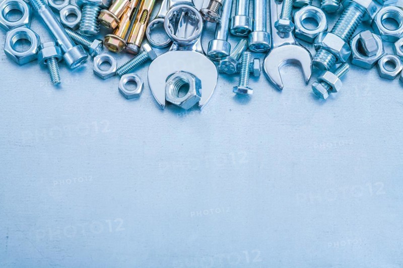 Anchor bolt Bolt nuts Hook spanner and flat spanner on metallic background Construction concept