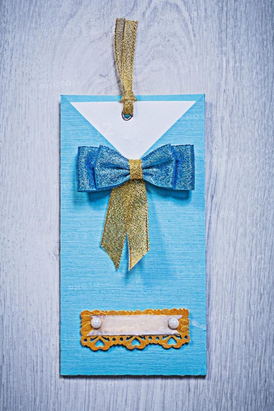 Blue invitation envelope on a grey wooden background
