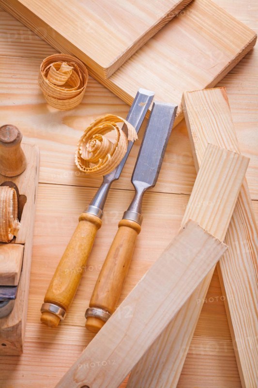 Carpenter's chisel and plane on wooden boards