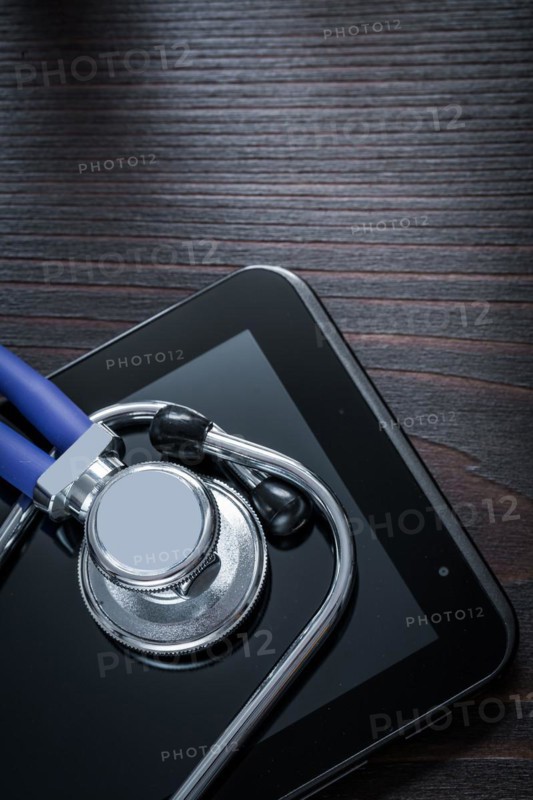 Copy space image of stethoscope and tonometer with print ribbon on vintage wooden background medicine concept