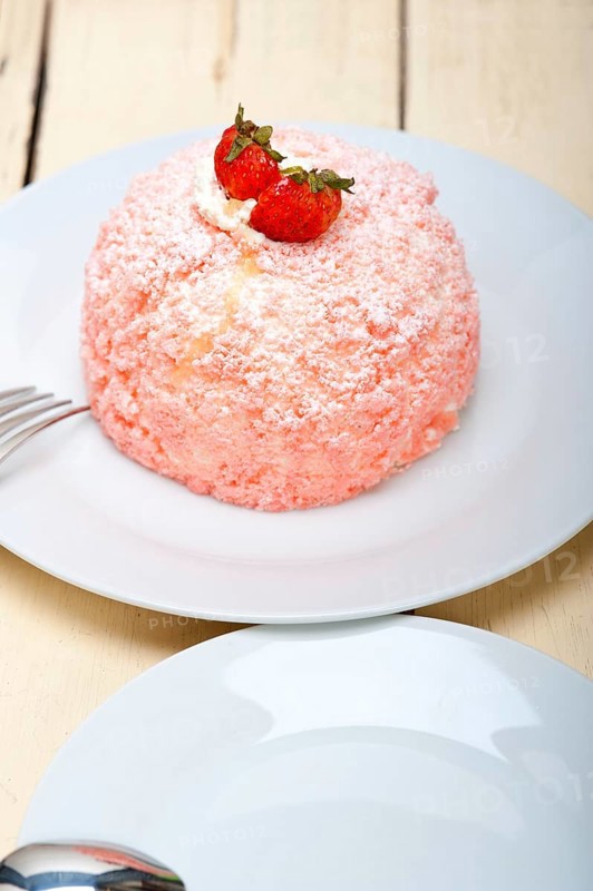 Fresh pink strawberry and whipped cream dessert macro close up