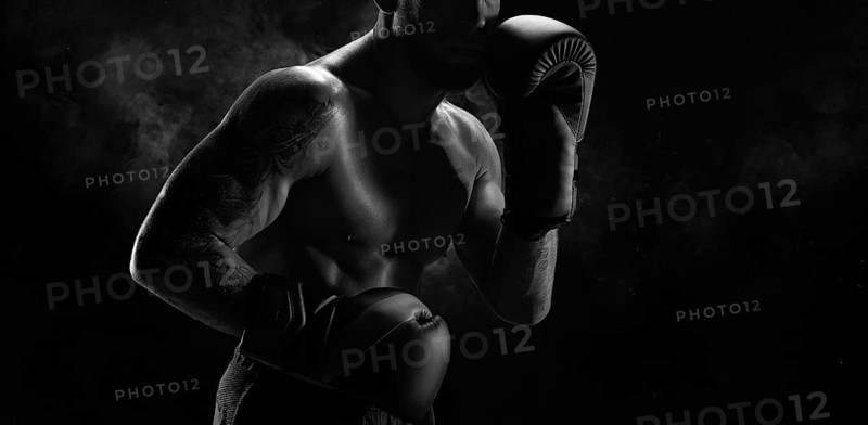 Noname image of a kickboxer on a dark background. The concept of mixed martial arts. MMA