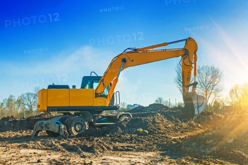 Excavator pouring ground from scoop