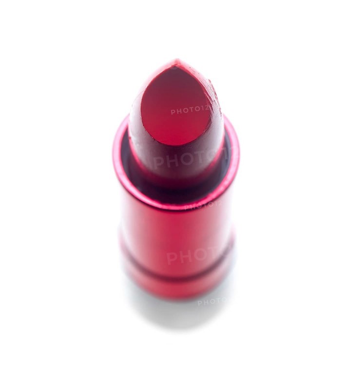 Vivid red lipstick tube over white background
