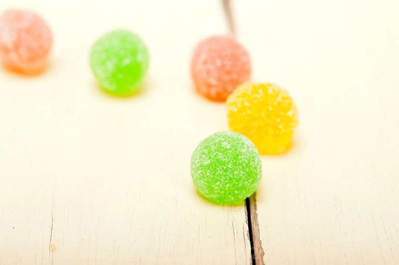 Sugar jelly fruit candy over white wood table