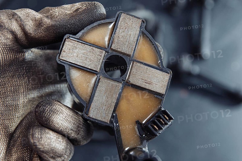 Engine ignition coil in hand of auto mechanic