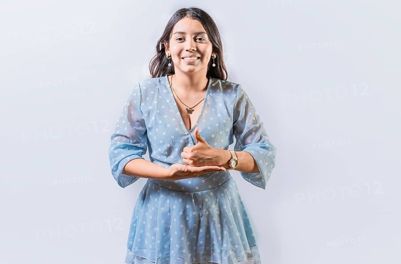 Girl gesturing help with hands in sign language. Person showing help gesture with hands in sign language