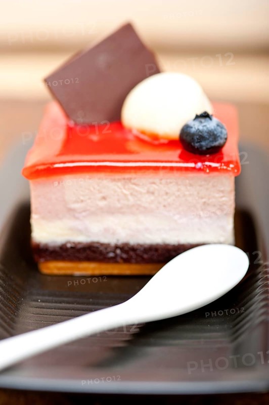 Fresh strawberry yogurt mousse with macaroon and blueberry on top
