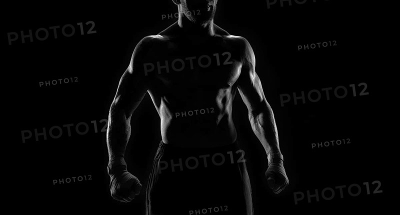 Noname image of a kickboxer on a dark background. The concept of mixed martial arts. MMA