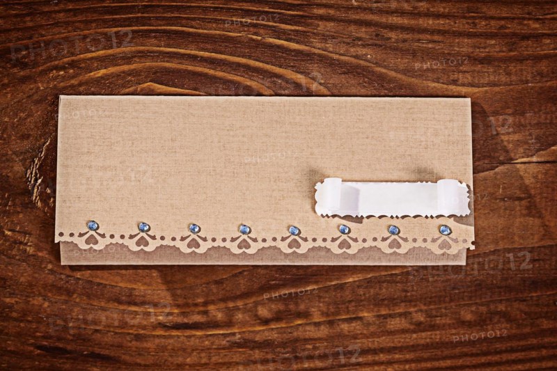 Envelope for invitation on wooden table