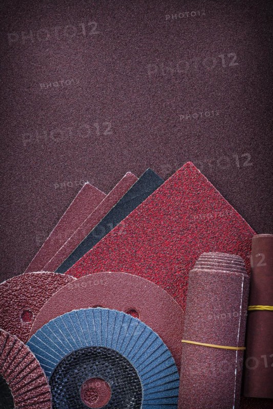 Heap of abrasive tools on polishing paper