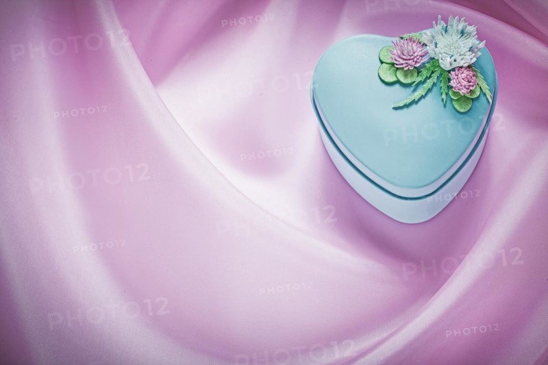 Blue present box on pink fabric background holidays concept