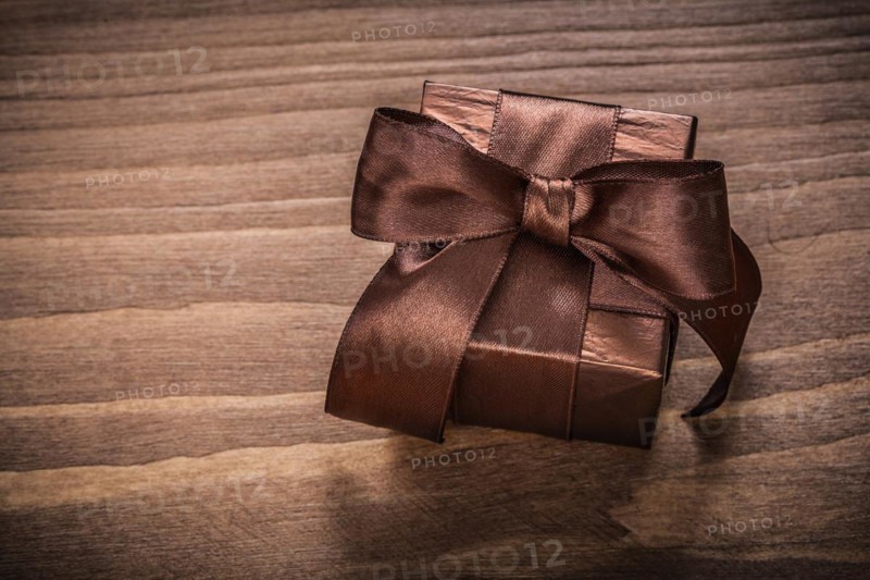 Boxed glittery gift container on vintage wooden board