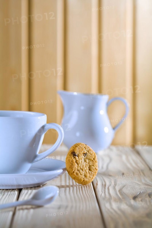 Blue coffee cup and jug on a white table