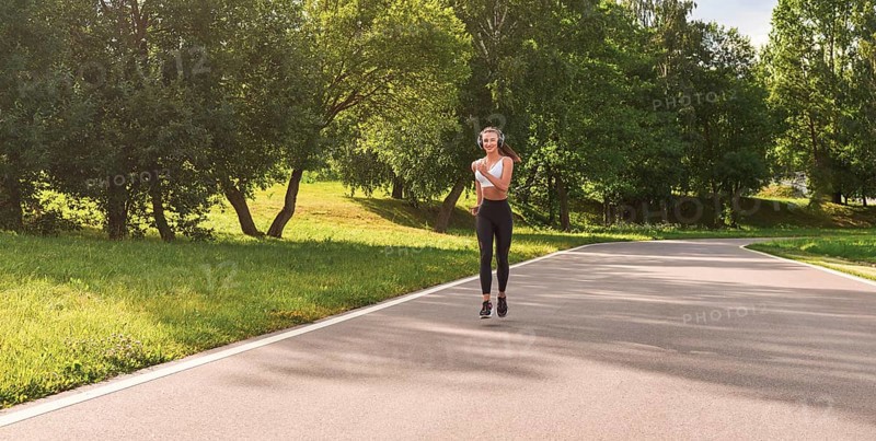Sports girl jogging in the park. The concept of a healthy lifestyle. Sports Equipment. Fitness style advertisement. mixed media